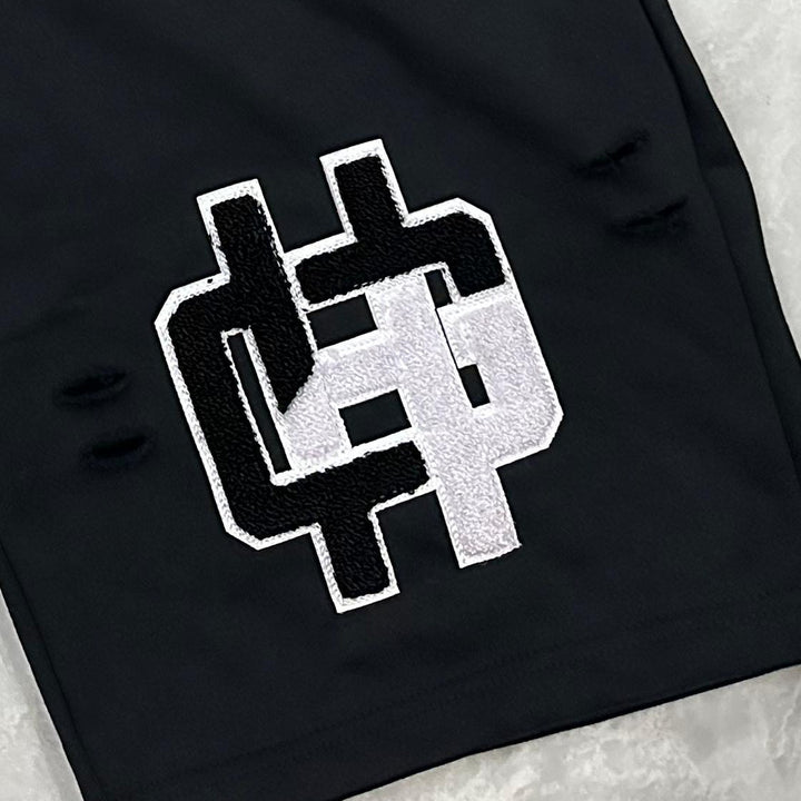 Close-up of the raised chenille HG monogram patch with satin stitch outline on Washed Black