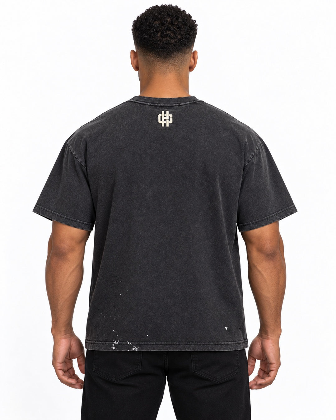 Back styling view of the Holy Godz washed charcoal tee with cream HG emblem